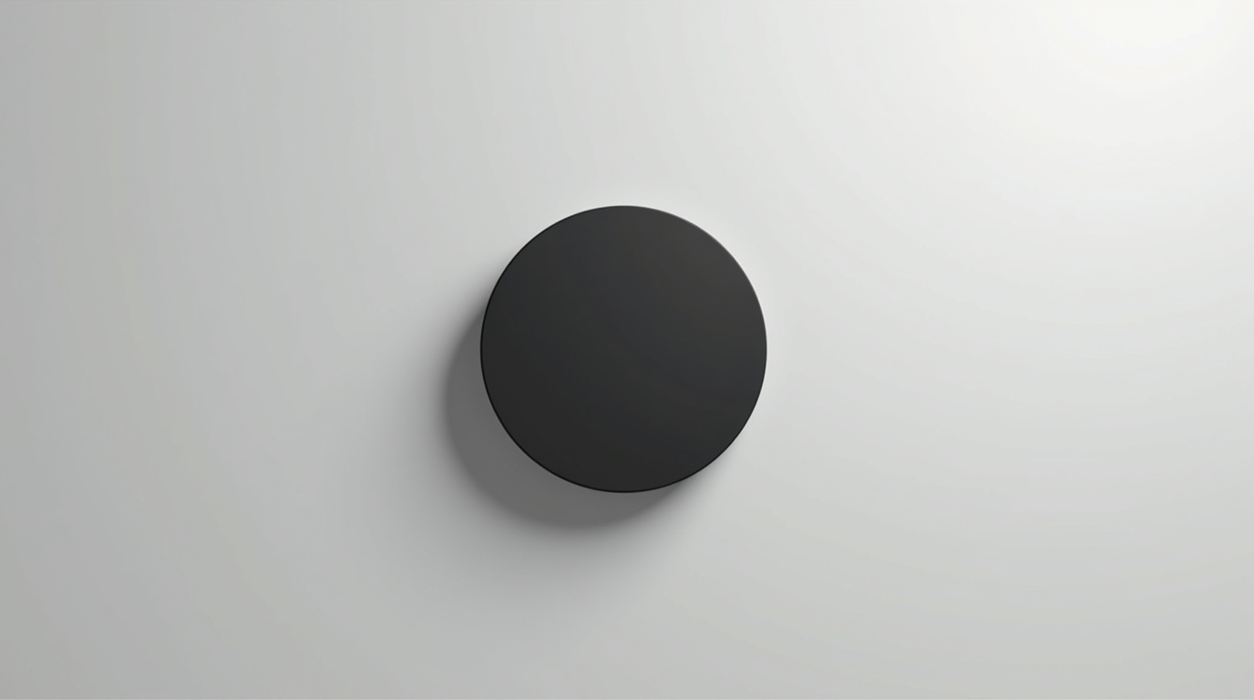 Minimalist black solid circle on a light grey background symbolizing presence over performance