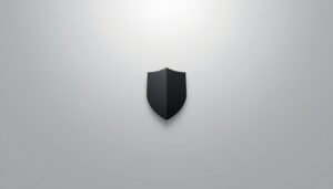 Minimalist black shield on a light grey background symbolizing quiet authority built through trust.