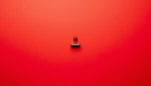 Toy stamp on a neon red background symbolizing misdirected regulation