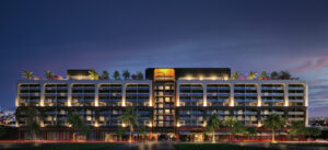 Front exterior of NoMad Residences Wynwood luxury condominium at dusk with illuminated architecture in Miami's Wynwood Arts District